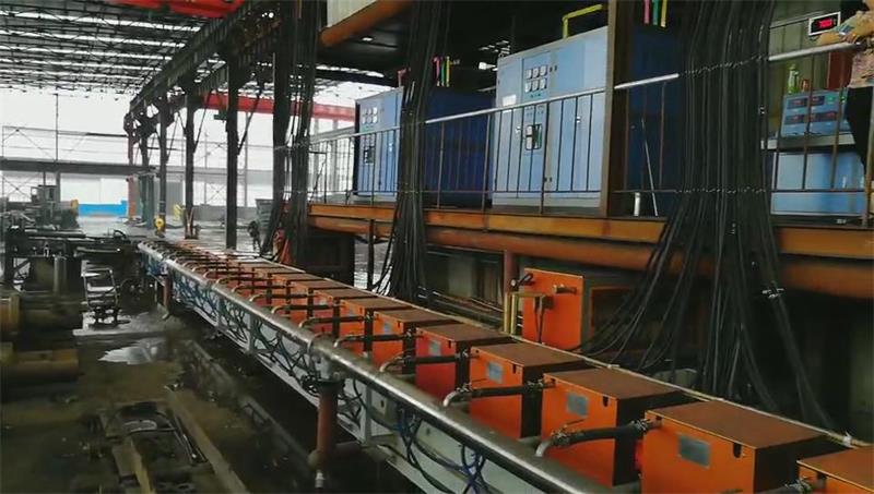 Induction heating system for temperature compensation of continuous casting and rolling billet